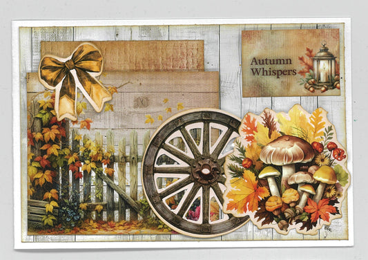 Autumn Whispers card sample 1 – landscape card with whitewashed timber background, golden bow, wagon wheel, autumn leaves and mushroom cluster die-cut embellishments