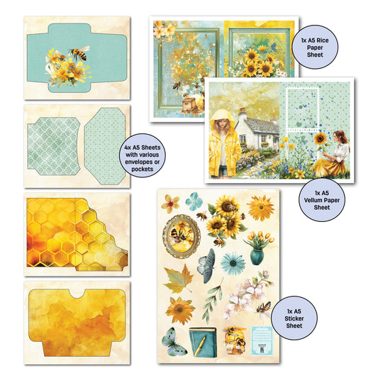 Honey Fields Gimme More Pack contents laid out showing A5 sticker sheet with sunflowers and bees, vellum sheet with cottage scene, rice paper with butterflies, and four envelope pocket pages with mixed patterns