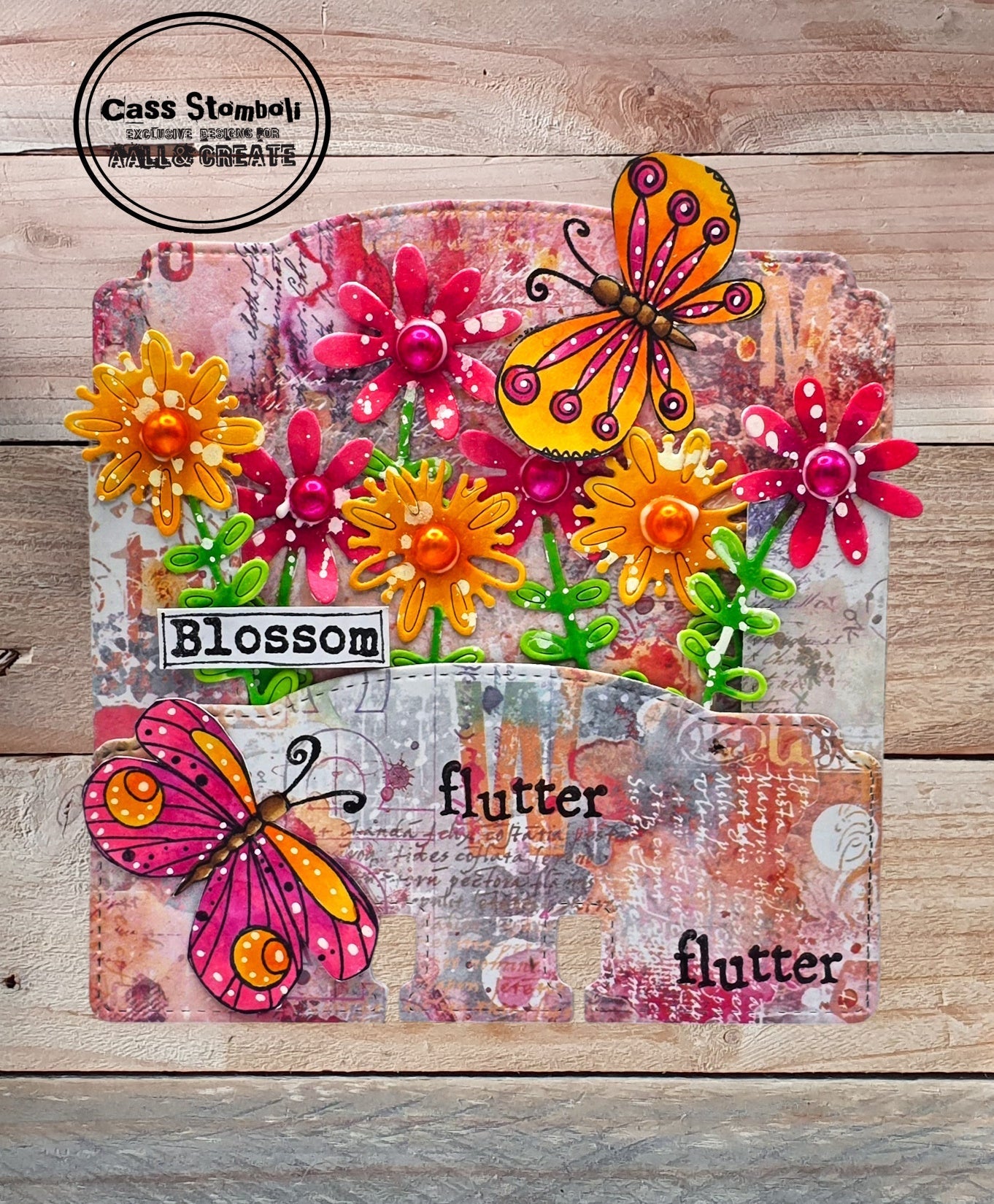 'Blossom flutter' mixed media card made with AALL & Create Floral Fantasy dies in orange, pink and yellow featuring butterflies and dimensional flowers on distressed pink background with vintage text overlay