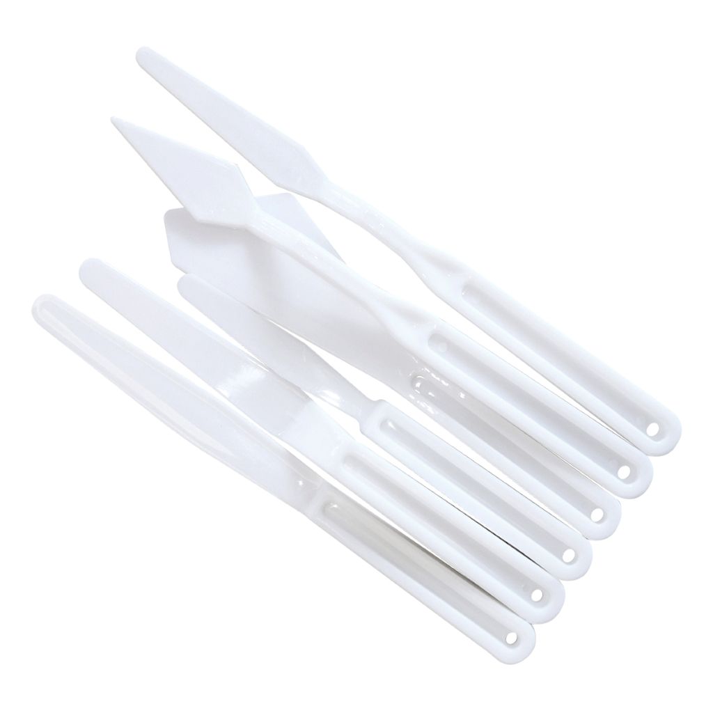 Set of white plastic palette knives on a white background.