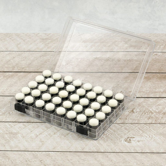 Sponge Daubers in a storage container on a wooden background.