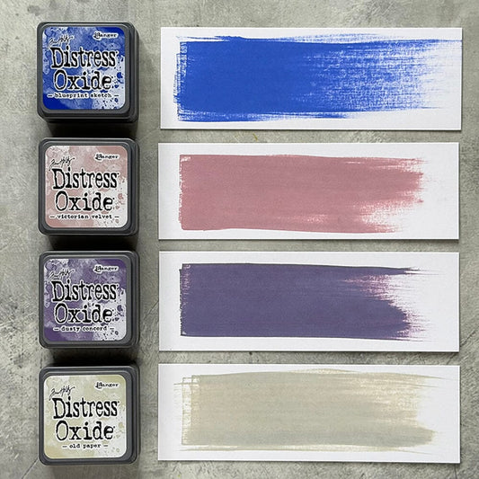 Four Ranger Distress Oxide ink pads from Kit 11 with swatched colours: Blueprint Sketch, Victorian Velvet, Dusty Concord and Old Paper, shown on white paper beside each labelled pad.