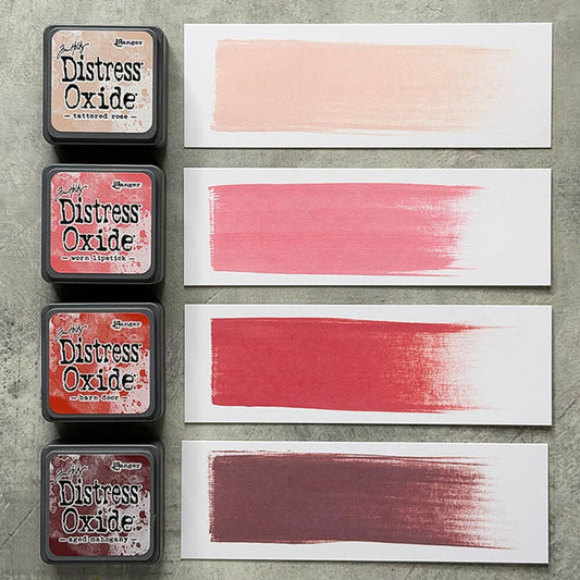 Four Ranger Distress Oxide ink pads from Kit 13 with swatched colours: Tattered Rose, Worn Lipstick, Barn Door and Aged Mahogany, shown on white paper beside each labelled pad.