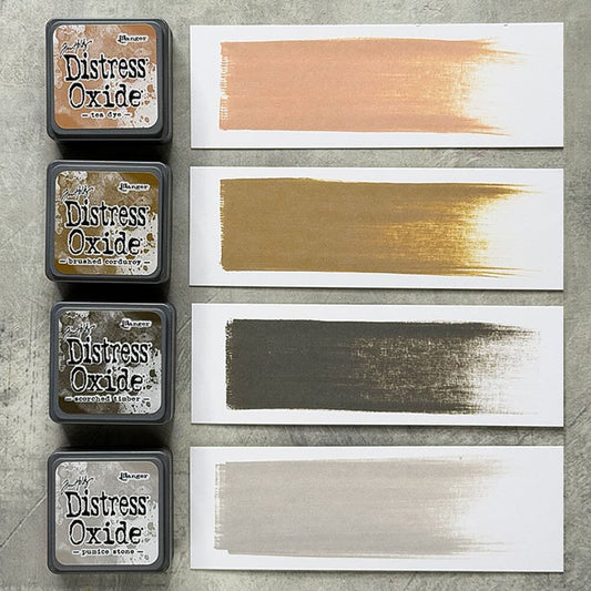 Four Ranger Distress Oxide ink pads from Kit 18 with swatched colours: Tea Dye, Brushed Corduroy, Scorched Timber and Pumice Stone, shown on white paper beside each labelled pad.
