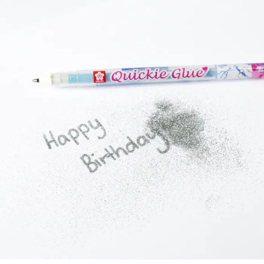 Sakura Quickie Glue Pen applied to paper with glitter showing precise adhesive control for card making