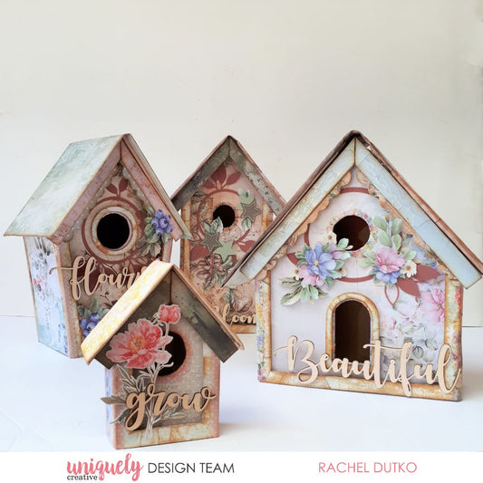 Decorative birdhouse kit sample by Rachel Dutko featuring elements from Uniquely Creative’s Botanical Chronicles and Floral Archives collections – includes four pastel birdhouses adorned with layered florals, paper embellishments, and nature-themed sentiments like “flourish,” “bloom,” “grow,” and “Beautiful.” A charming display of handcrafted artistry and mixed media design.