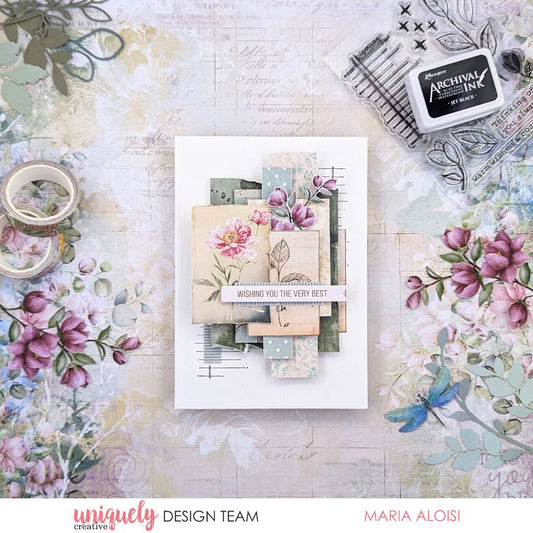 Handmade greeting card by Maria Aloisi using Uniquely Creative Floral Archives collection – features layered florals, pastel tones, and vintage textures with a central sentiment “WISHING YOU THE VERY BEST.” Surrounded by crafting supplies like floral washi tape, stamps, and die cuts for a charming, artistic presentation.