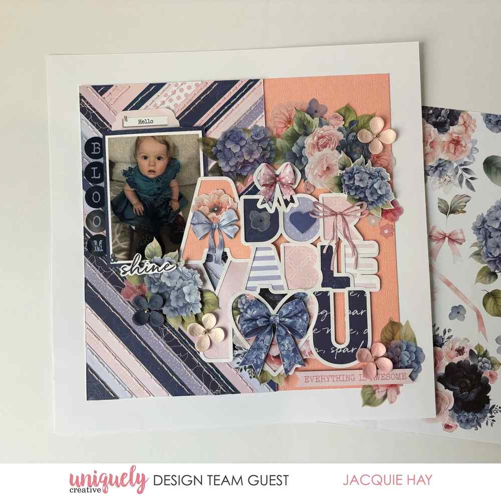 Floral scrapbook layout with a baby photo, diagonal striped papers and an Adorable You overlay backed with assorted patterned papers