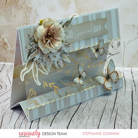 Tent-fold handmade card by Stephanie Donnini using Uniquely Creative Bohemian Escape collection – features a gold foil acetate overlay with botanical leaf design, layered butterflies, striped background, and floral embellishments. Sentiment reads “on your Special DAY,” perfect for elegant celebrations.