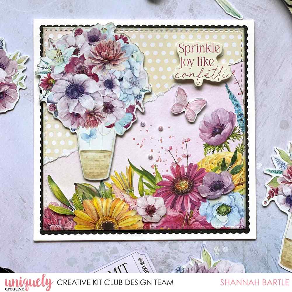 Square card with a scalloped square layered under a stitched square die cut, layered florals, a hot air balloon and a Sprinkle joy like confetti sentiment