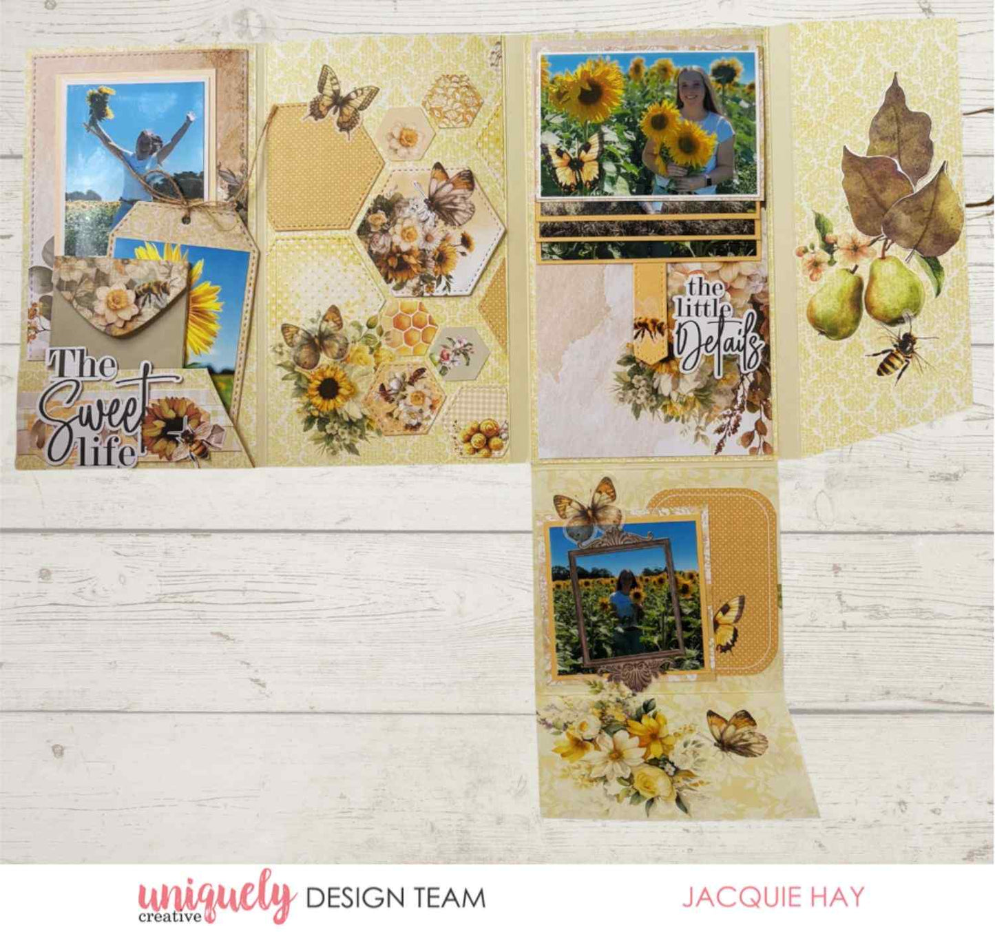Uniquely Creative Sweet As Honey scrapbook album sample showing fold-out layout with sunflower photos, honeycomb hexagon panels, butterfly and bee embellishments, and "The Sweet Life" title