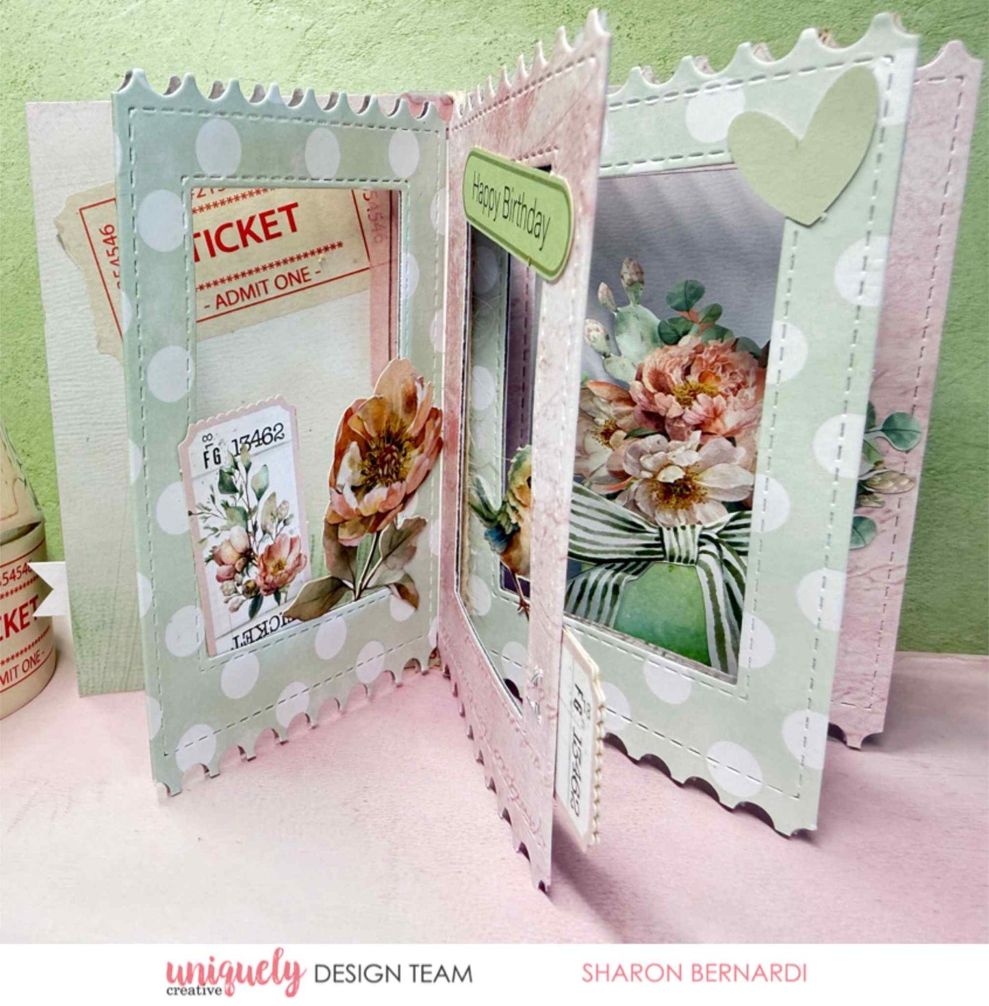 Tea and Tranquility handmade card by Uniquely Creative design team — "Happy Birthday" card with scalloped ticket-shaped panels, polka dot papers, floral bouquet and postage stamp die-cuts, striped ribbon bow, and heart embellishment in soft sage, blush, and cream