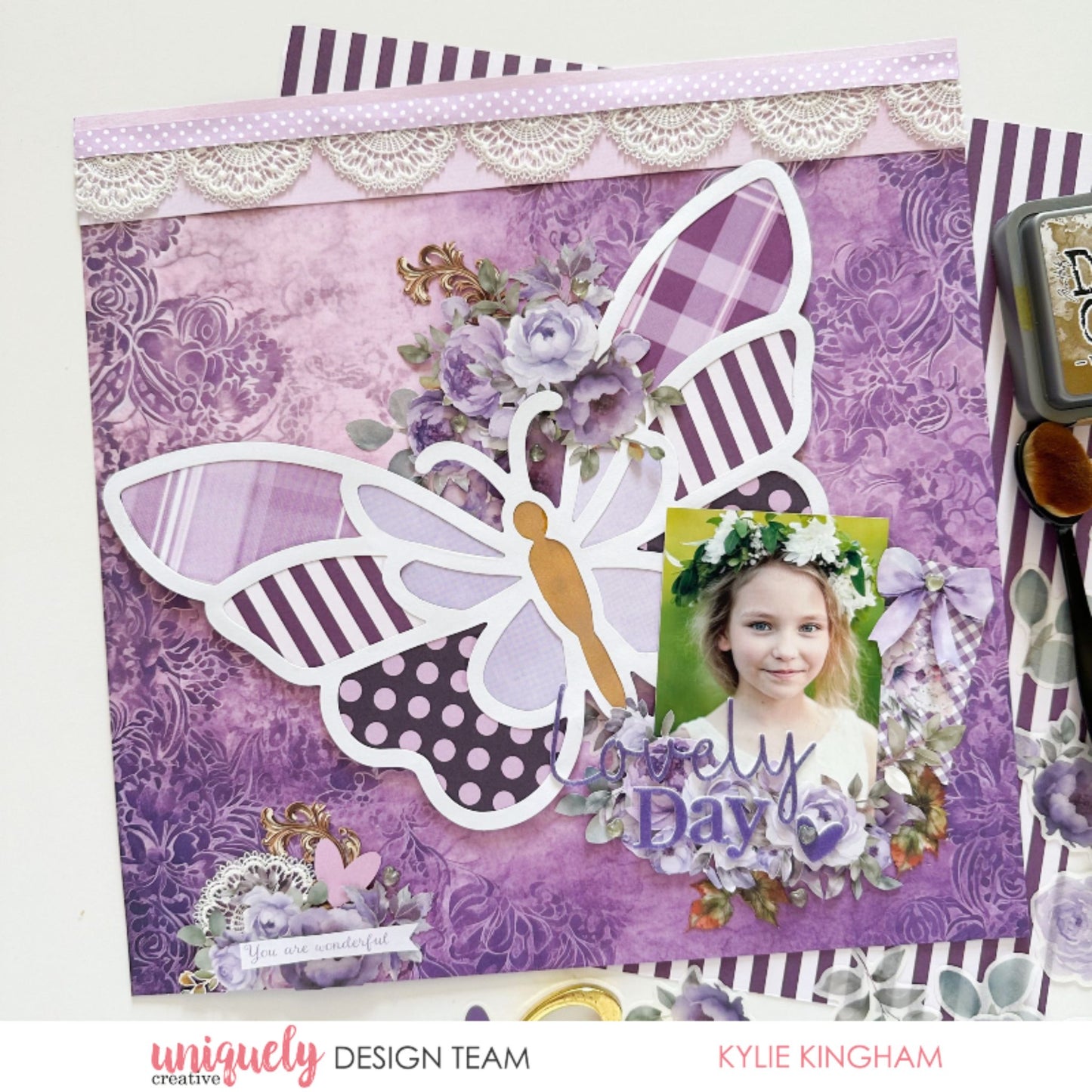 Scrapbook layout with Uniquely Creative Ultraviolet Delight collection featuring purple damask papers, butterfly die cut, and lace trim by Kylie Kingham