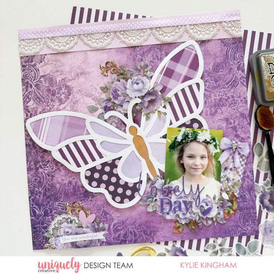 Scrapbook layout with Uniquely Creative Ultraviolet Delight collection featuring purple damask papers, butterfly die cut, and lace trim by Kylie Kingham