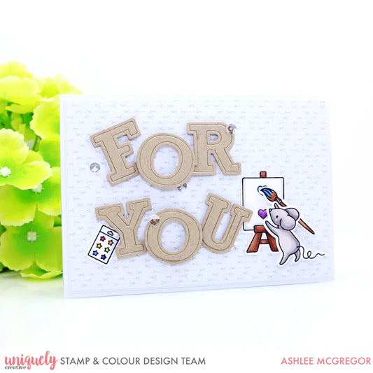 "Sample card using Uniquely Creative Uppercase Outline Alphabet Dies spelling FOR YOU with kraft die-cut letters on white dotted background with illustrated mouse and flowers