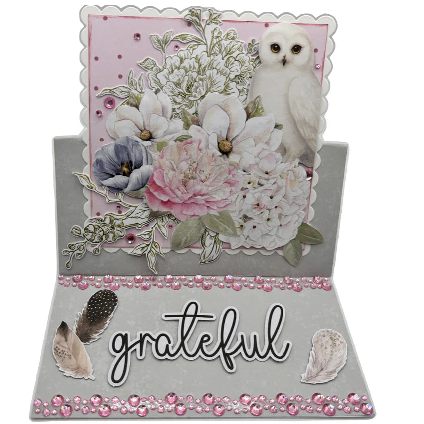 Handmade easel card using Uniquely Creative Square Photo Mat Border Die Scalloped with white owl, pink and white florals, grateful sentiment and pink rhinestone embellishments on grey cardstock