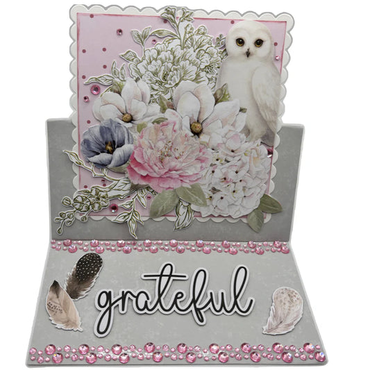 Handmade easel card using Uniquely Creative Square Photo Mat Border Die Scalloped with white owl, pink and white florals, grateful sentiment and pink rhinestone embellishments on grey cardstock