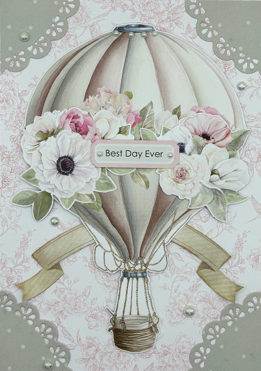 Handmade card using Uniquely Creative Delicate Doily Die with sage green die-cut doilies in the corners, hot air balloon, pink florals and Best Day Ever sentiment on soft pink background