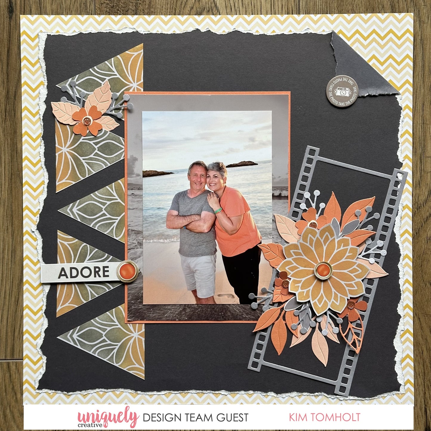 Adore scrapbook layout with beach photo on torn black cardstock using Uniquely Creative Written in the Stars collection featuring yellow chevron background, floral die-cuts in orange, film strip frames and layered embellishments