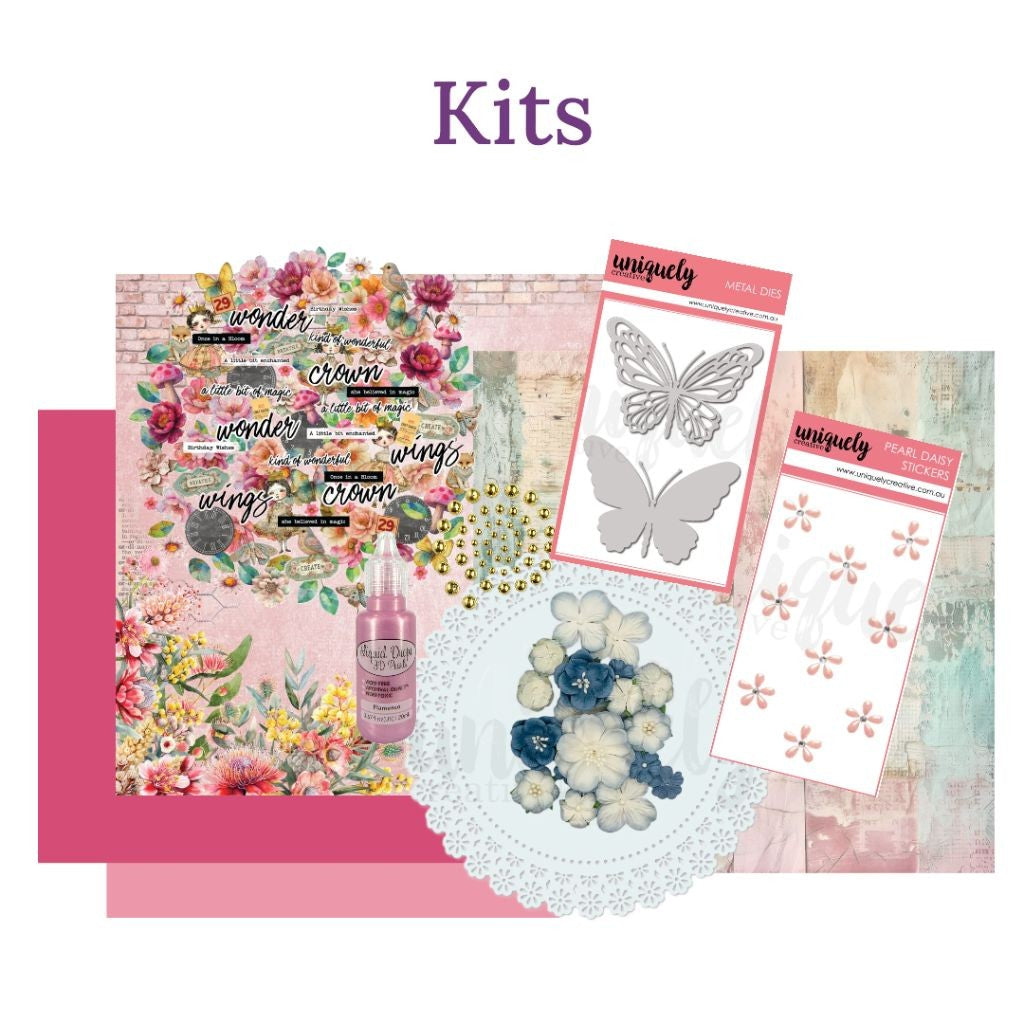 Kits Collection header on Handmade Haven site. Shows a collection of papers and embellishments like you might find in a scrapbook or card making kit. 