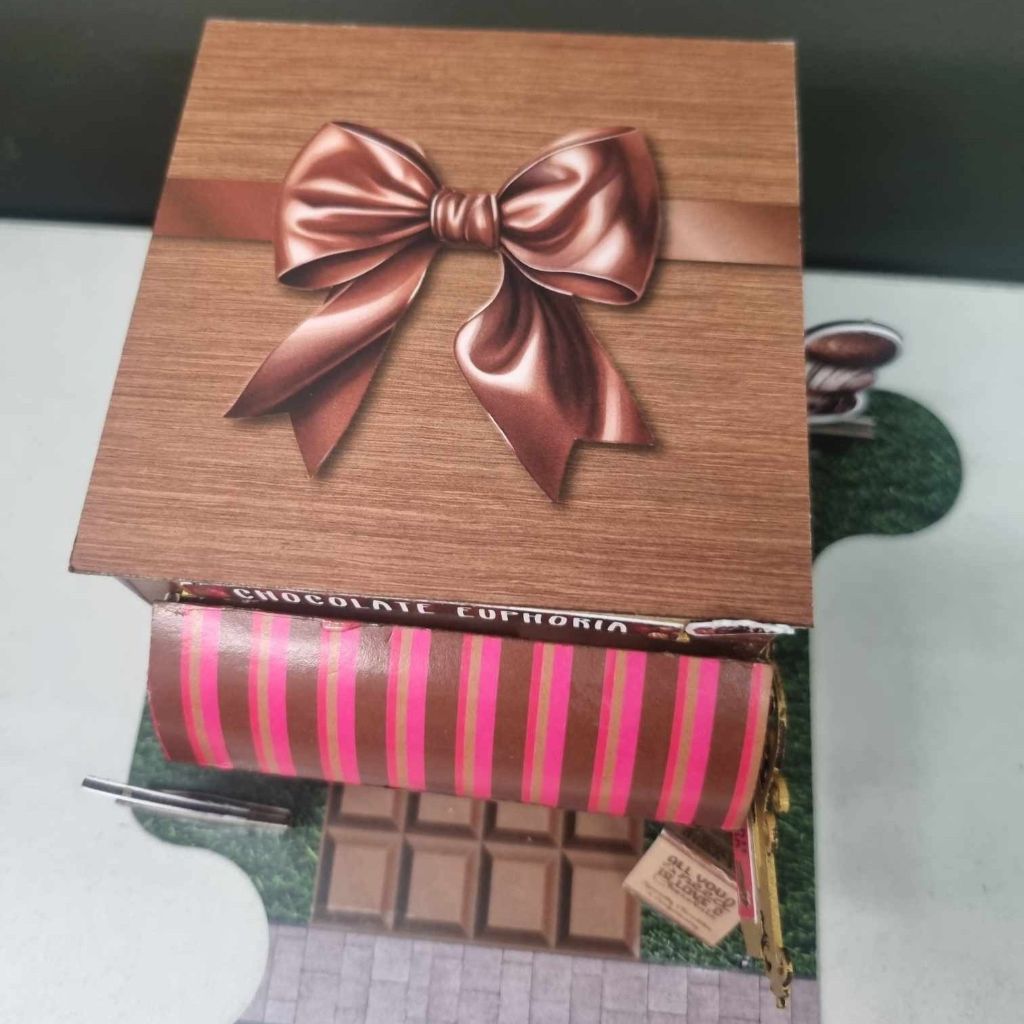 Top-down view of the Chocolate Euphoria miniature building showing the copper bow detail on the rooftop