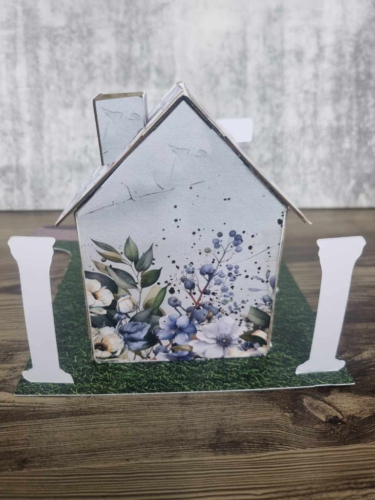 3Quarter Designs Enchanting Treasures Boutique Gift Shop miniature building rear view showing blue and white floral botanical paper on the back wall, ornate white columns, and grass base board