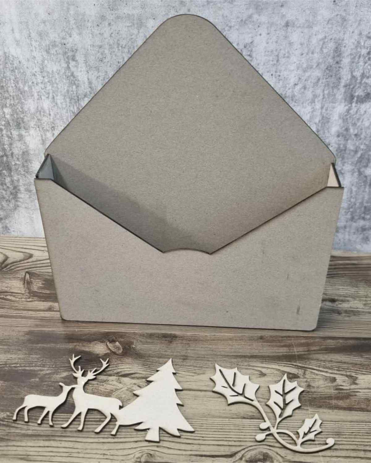 3Quarter Designs Christmas Envelope Box assembled showing the open envelope box with chipboard deer, tree and holly embellishments