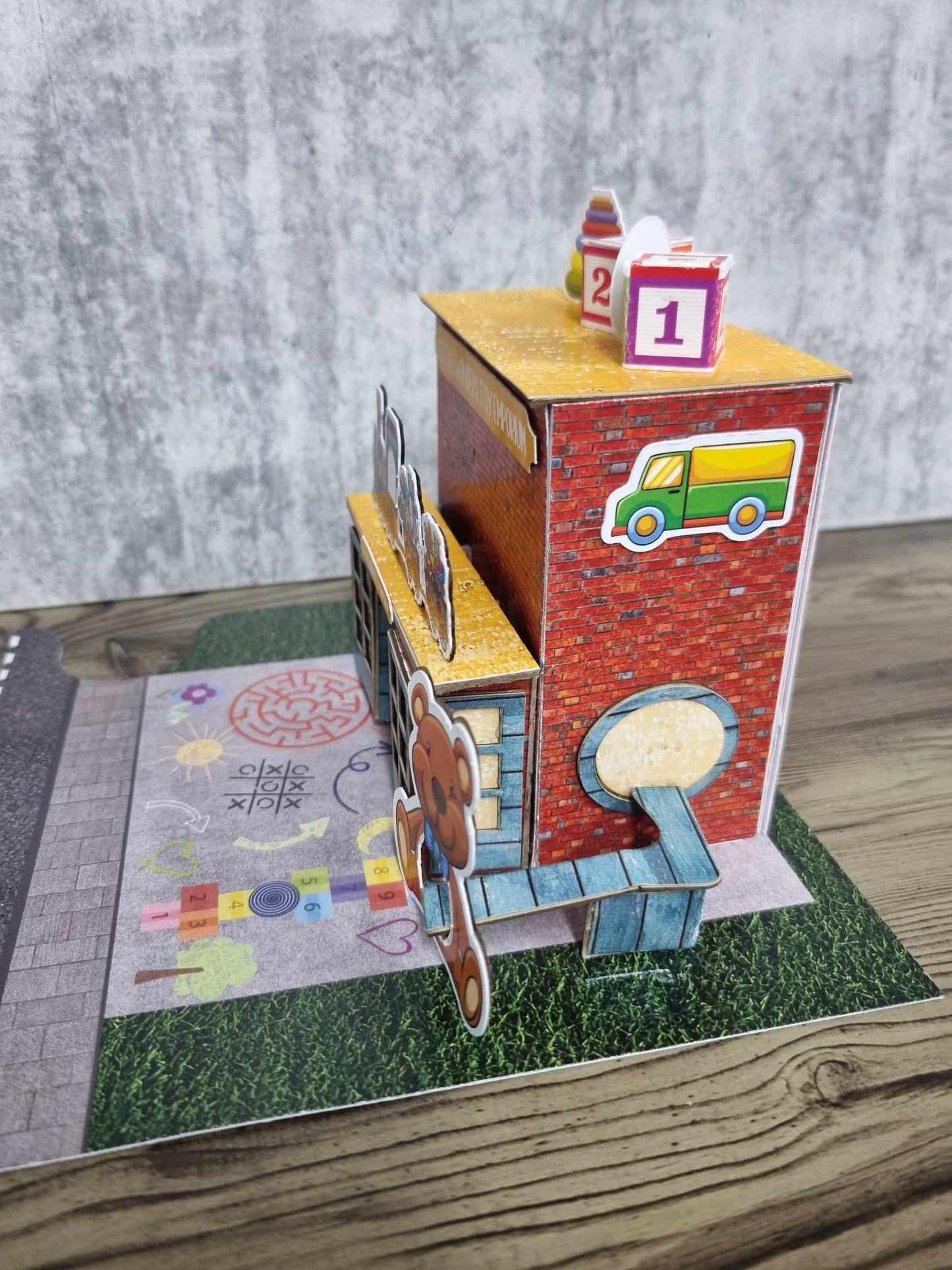 3Quarter Designs Little Wonders Toy Emporium side angle showing slide detail, and jigsaw base board with road section