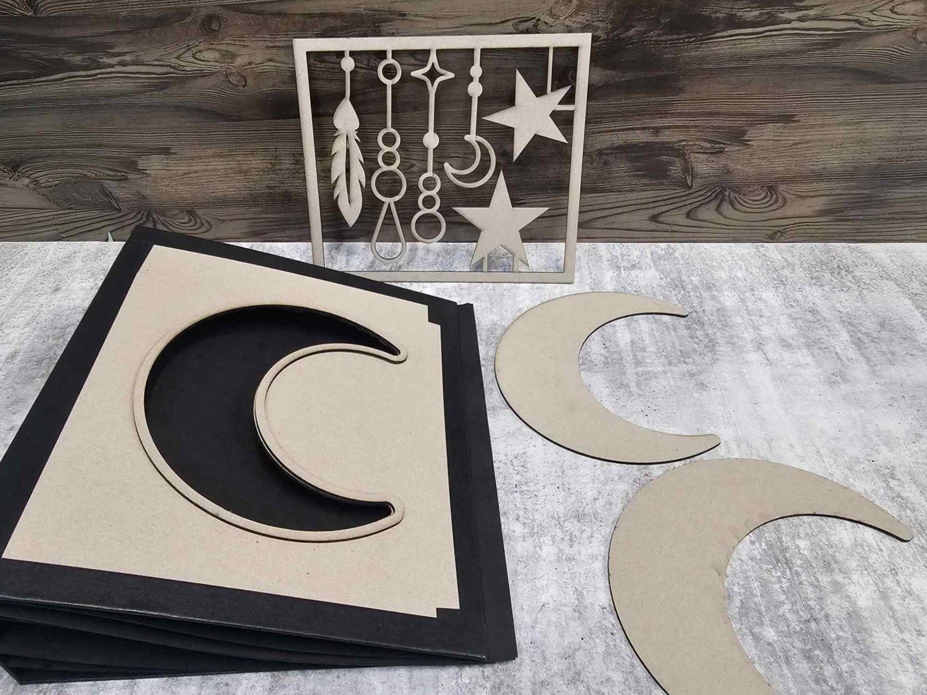 Moon Album Base Kit components laid flat including assembled album, crescent moon chipboard on cover, and dangles design