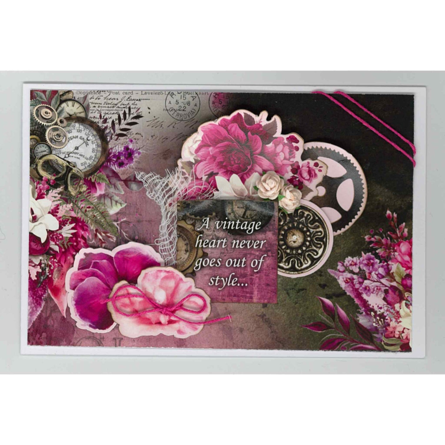 Handmade landscape card using Mrs Aeronaut kit with layered cerise peonies, steampunk gears, vintage clock and lace, with A Vintage Heart Never Goes Out of Style sentiment on dark floral background
