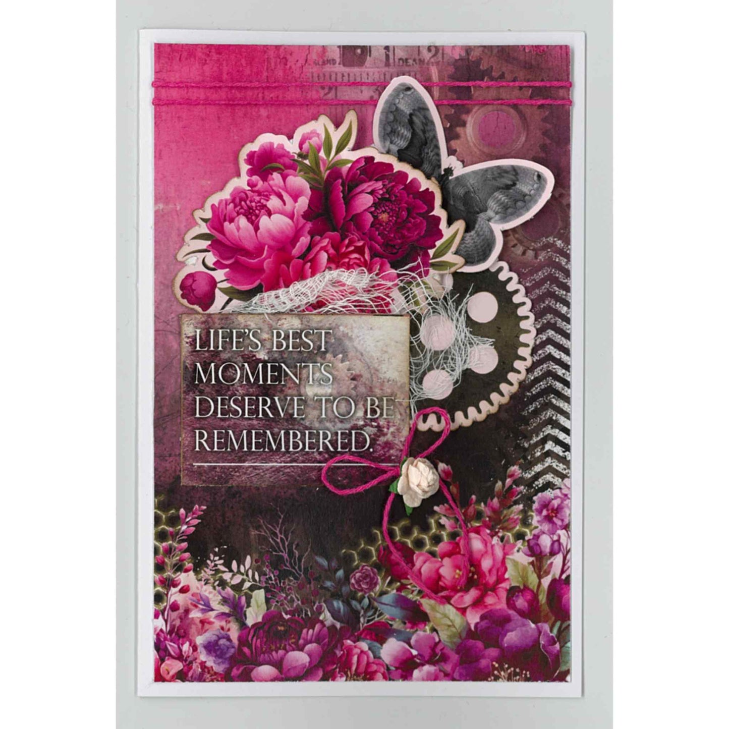 Handmade portrait card using Mrs Aeronaut kit with deep cerise peonies, steampunk butterfly, large gear, lace and chevron background, with Life's Best Moments Deserve to Be Remembered sentiment on bright cerise and dark background