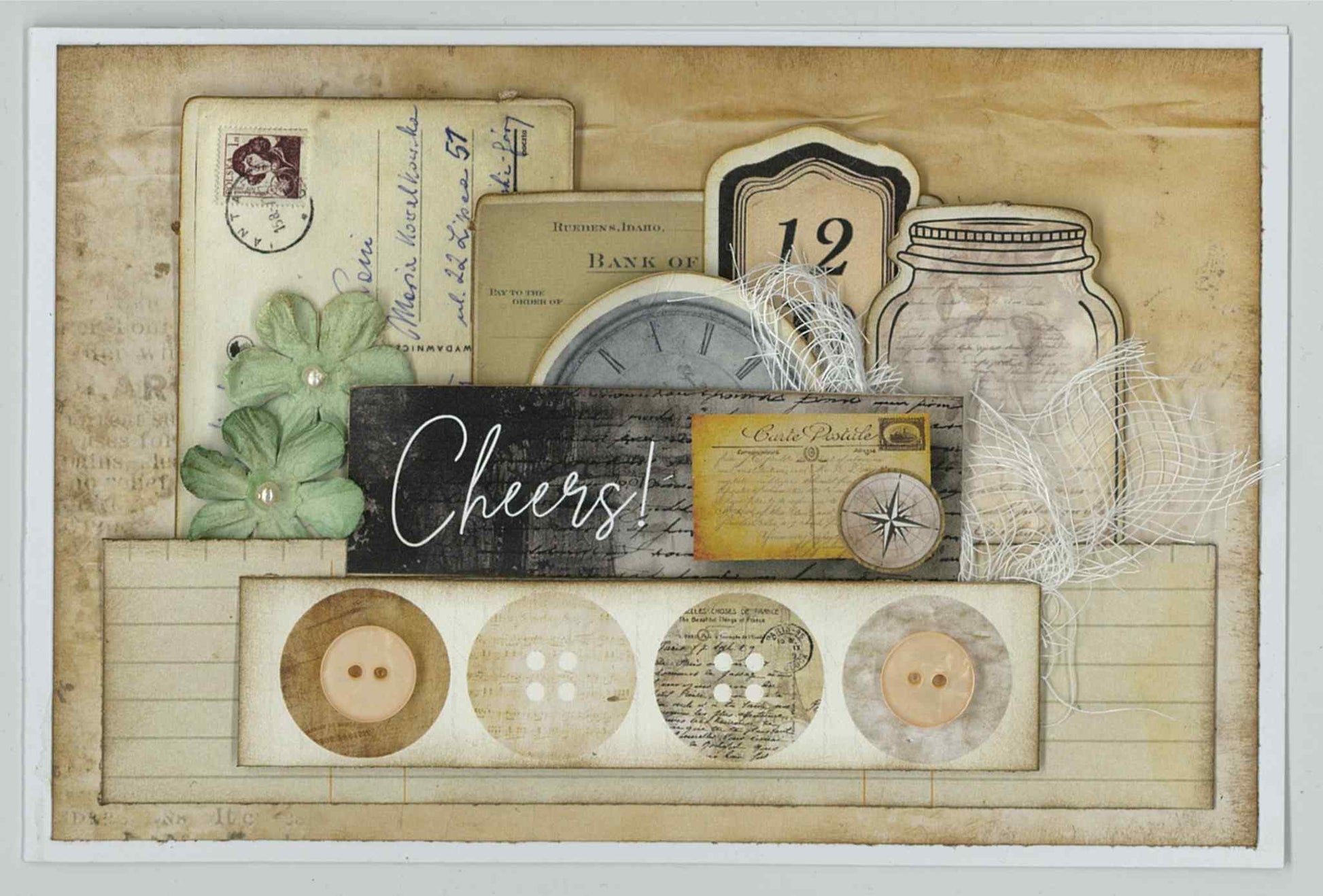3Quarter Designs Paper Tales card sample showing Cheers landscape card with layered vintage postcard, bank document, clock, compass, mason jar die-cuts, cheesecloth and paper flowers