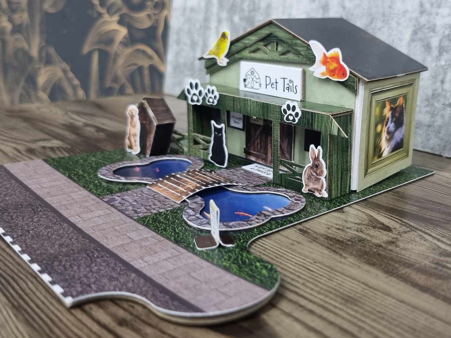 3Quarter Designs Pet Tails Pet Shop right side view showing the photo frame windows with goldfish and rabbit illustrations on the sage green wall
