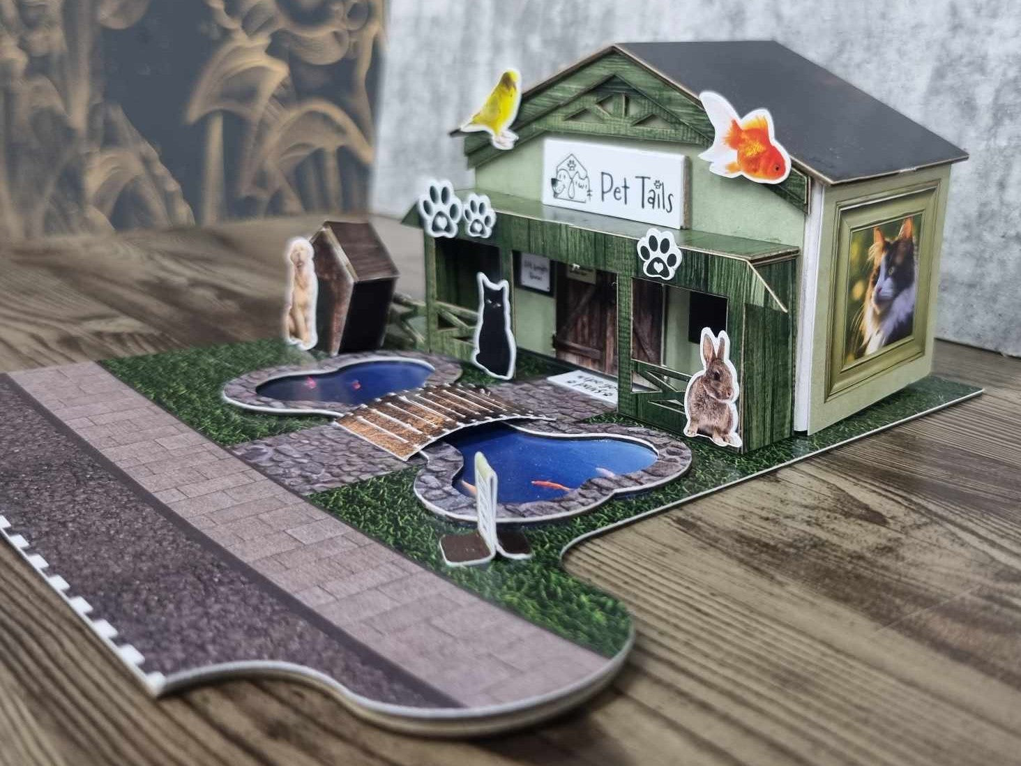 3Quarter Designs Pet Tails Pet Shop right side view showing the photo frame windows with goldfish and rabbit illustrations on the sage green wall