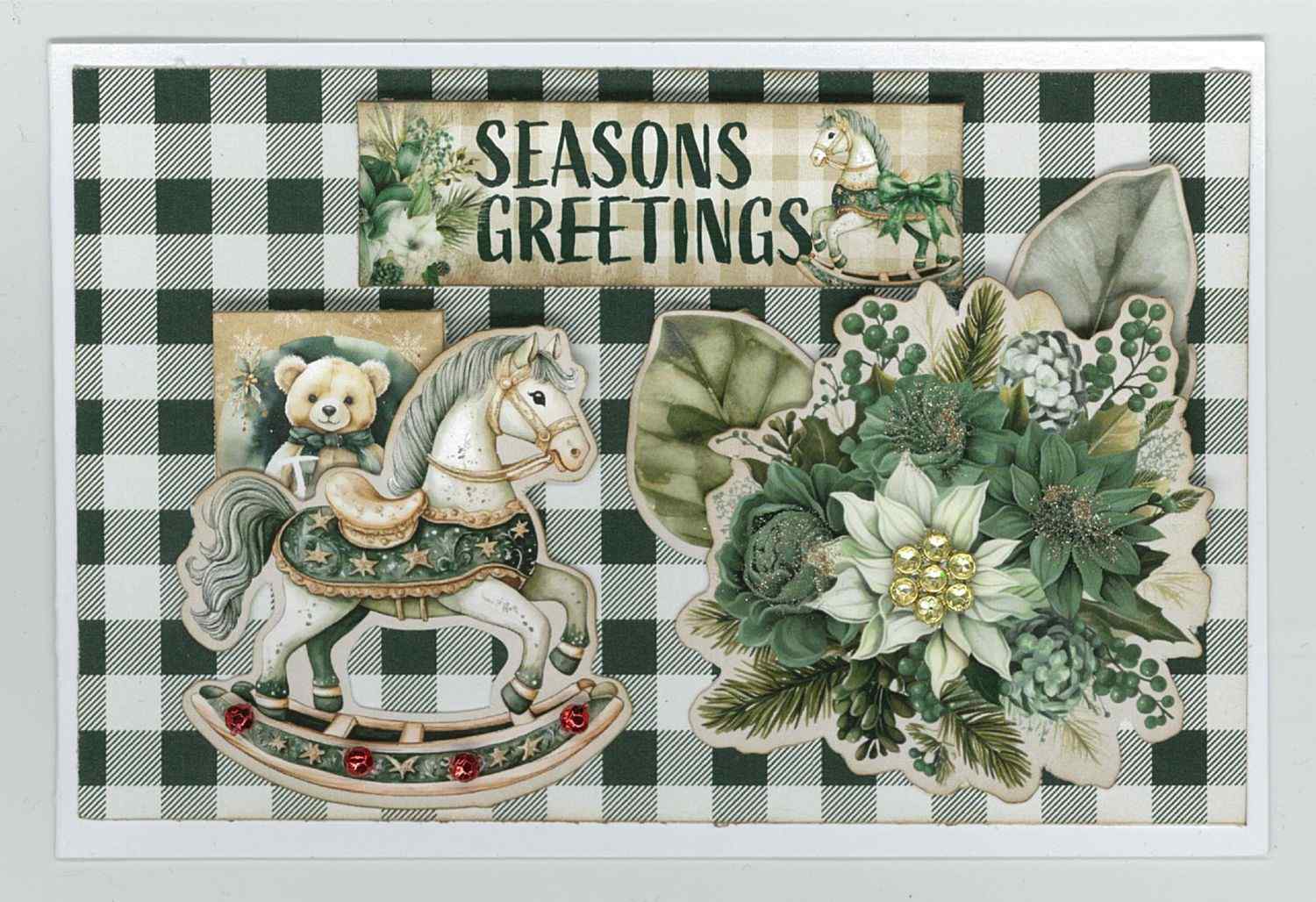 Pine Festivities card sample showing a landscape card with green and cream buffalo check background, die-cut rocking horse, teddy bear, poinsettia cluster and Seasons Greetings word strip