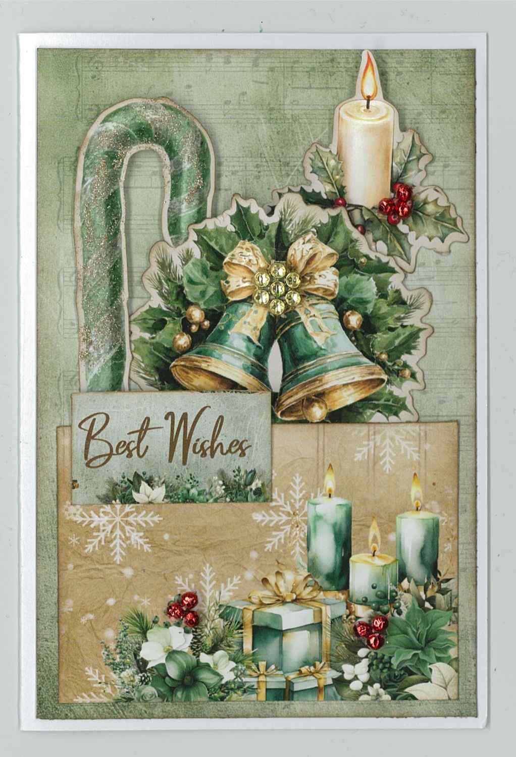 Pine Festivities card sample showing a portrait card with sage green sheet music background, die-cut candy cane, Christmas bells with holly and gold bow, candle with holly, green candles and Best Wishes word tile