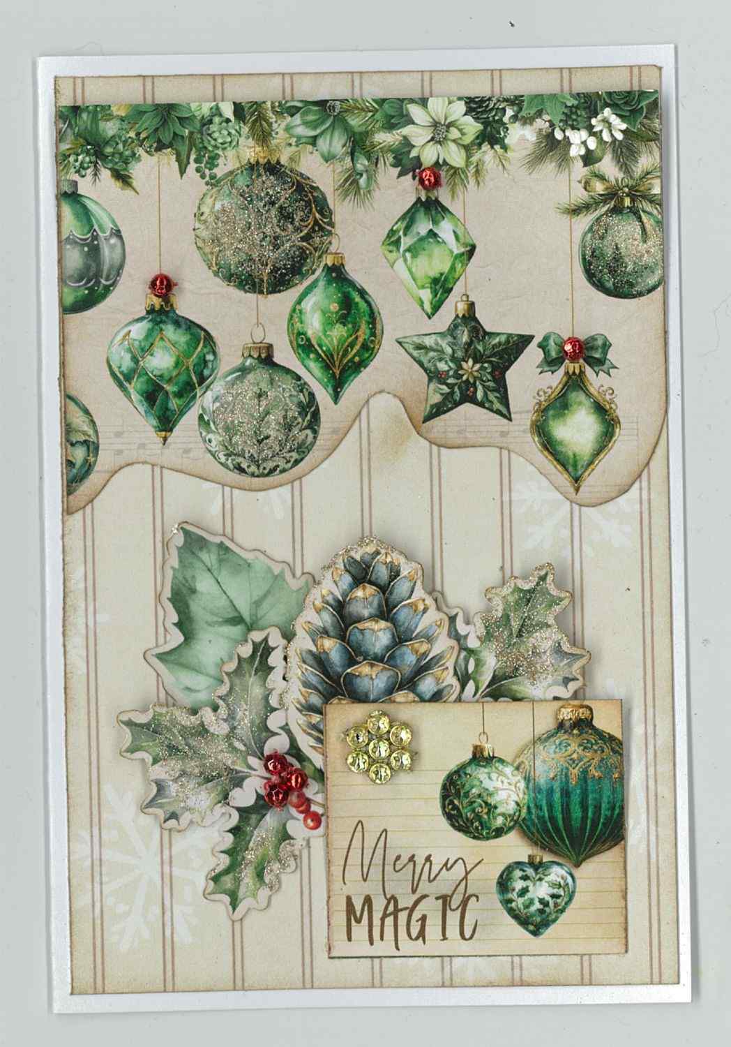 Pine Festivities card sample showing a portrait card with cream striped background, die-cut hanging green Christmas baubles and ornaments across the top, holly with red berries, pine cone and Merry Magic word tile