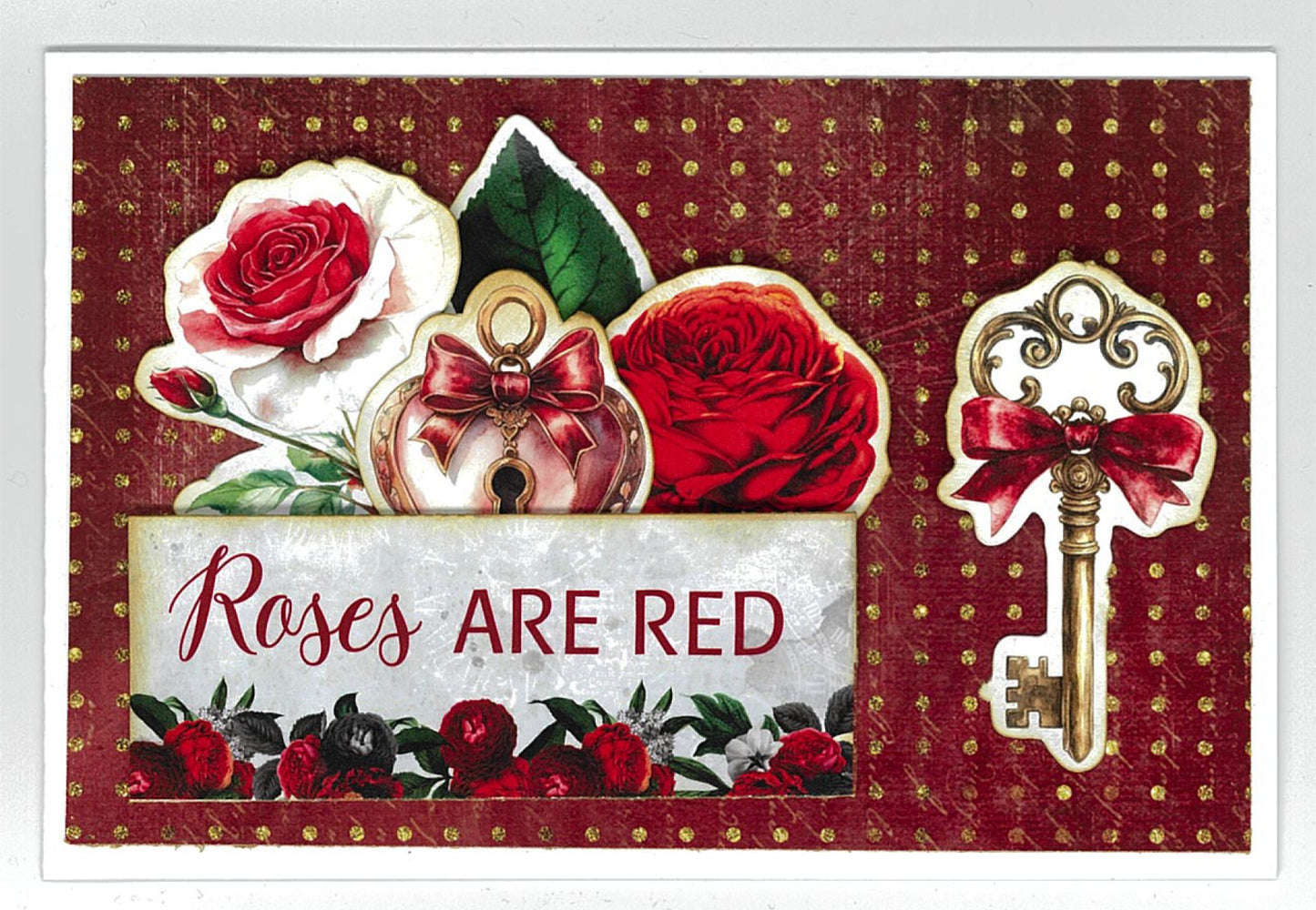 Red Queen card sample featuring roses are red sentiment with red and white roses, ornate perfume bottle charm, vintage key with bow and rose border on burgundy dotted background