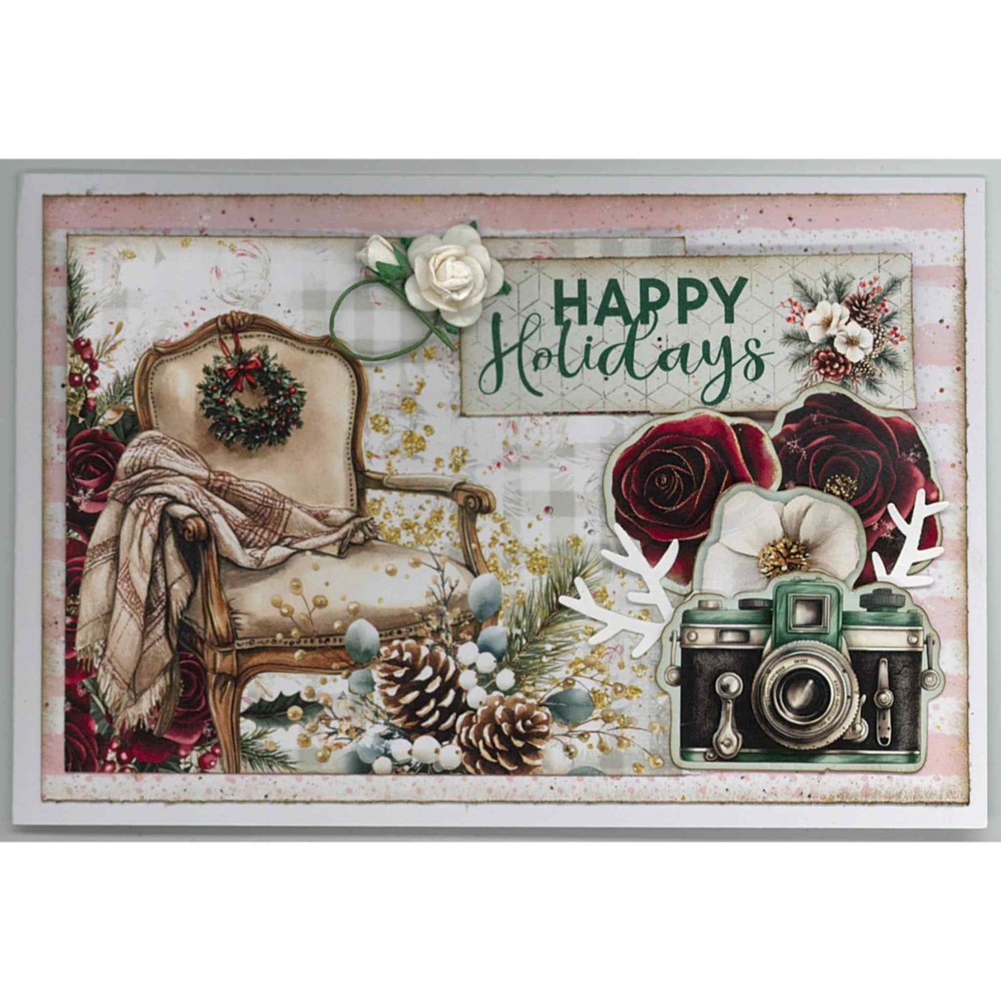 Handmade Silent Night Christmas card featuring cream armchair with tartan throw and wreath, vintage camera, burgundy and cream roses, pine cones, white paper flower and Happy Holidays sentiment on pink stripe background