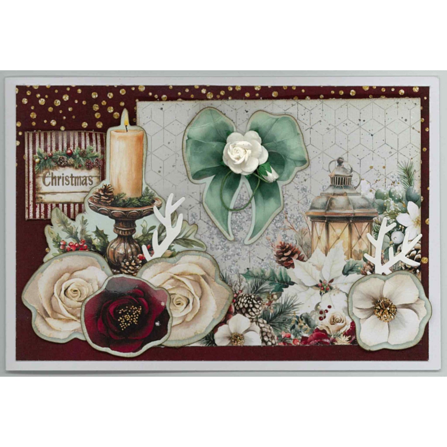Handmade Silent Night Christmas card featuring pillar candle on ornate stand, glowing lantern, mint bow with white paper flower, cream and burgundy roses, holly, pine cones and Christmas sentiment on burgundy and hexagon background