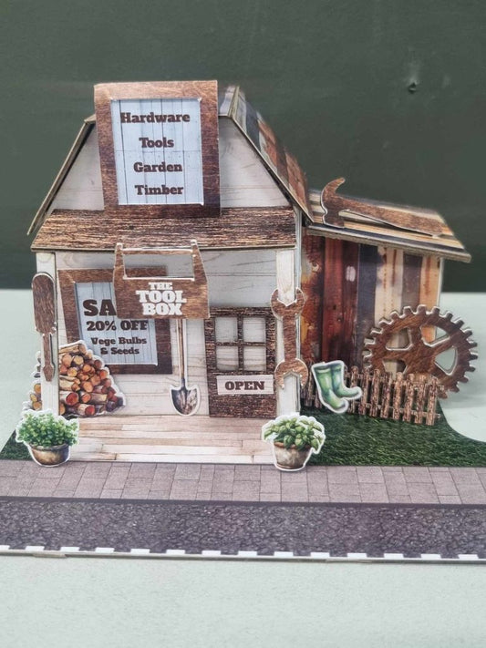 Assembled Toolbox miniature hardware store with weathered timber cladding, corrugated iron roof, and Hardware Tools Garden Timber dormer sign