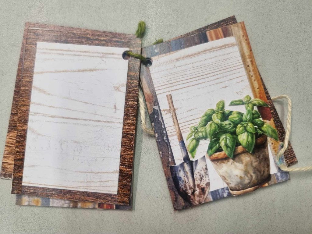 Sample mini album for The Toolbox open to a spread with a plain journaling page and a garden spade with potted basil illustration