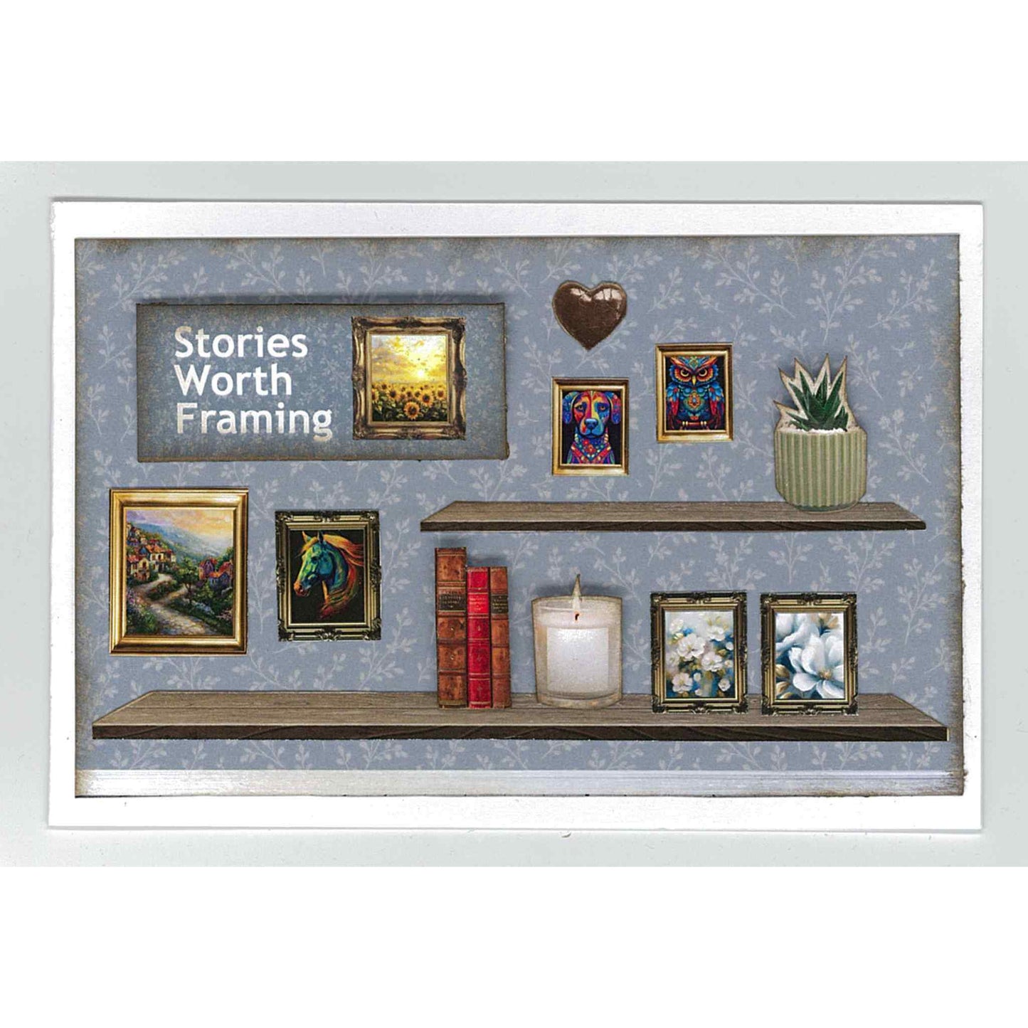 Timeless Gallery sample card — Stories Worth Framing sentiment on dusty blue tonal floral background with two timber floating shelves, multiple gold and dark framed paintings including sunflower field, horse portrait, village scene, owl and abstract artworks, stacked red books, candle, chocolate heart sculpture and succulent