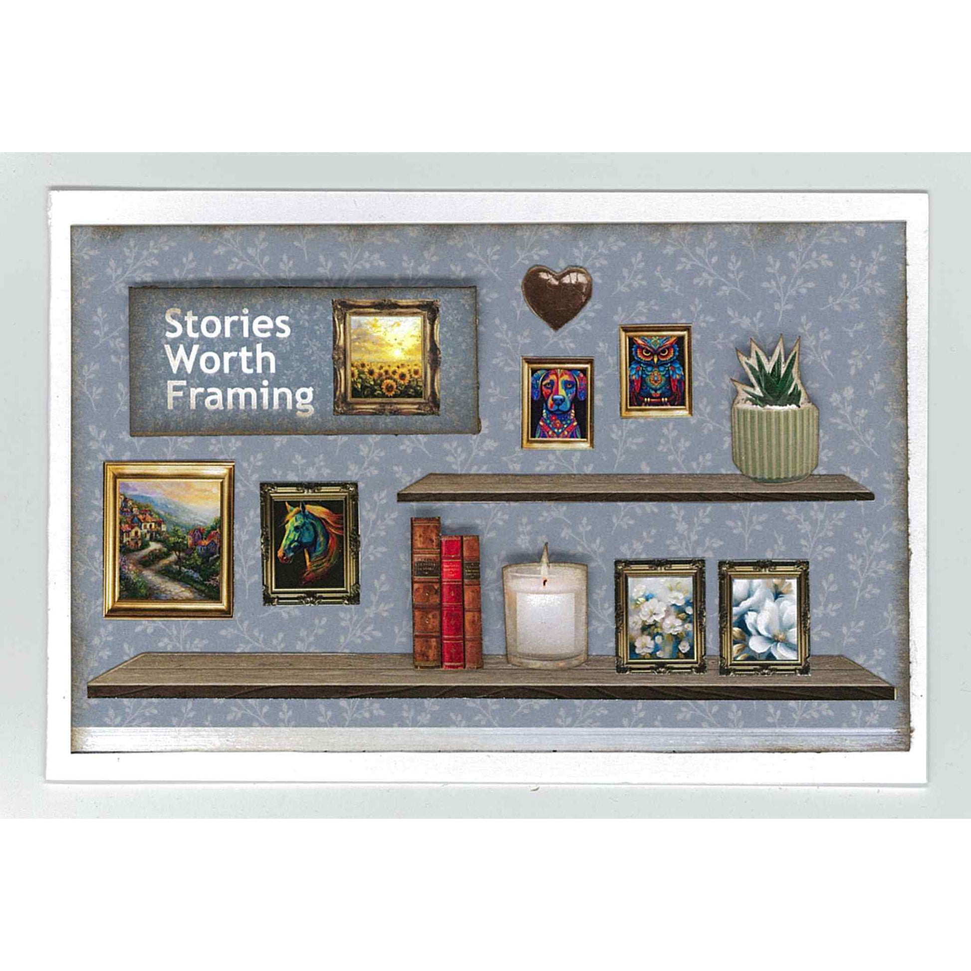 Timeless Gallery sample card — Stories Worth Framing sentiment on dusty blue tonal floral background with two timber floating shelves, multiple gold and dark framed paintings including sunflower field, horse portrait, village scene, owl and abstract artworks, stacked red books, candle, chocolate heart sculpture and succulent