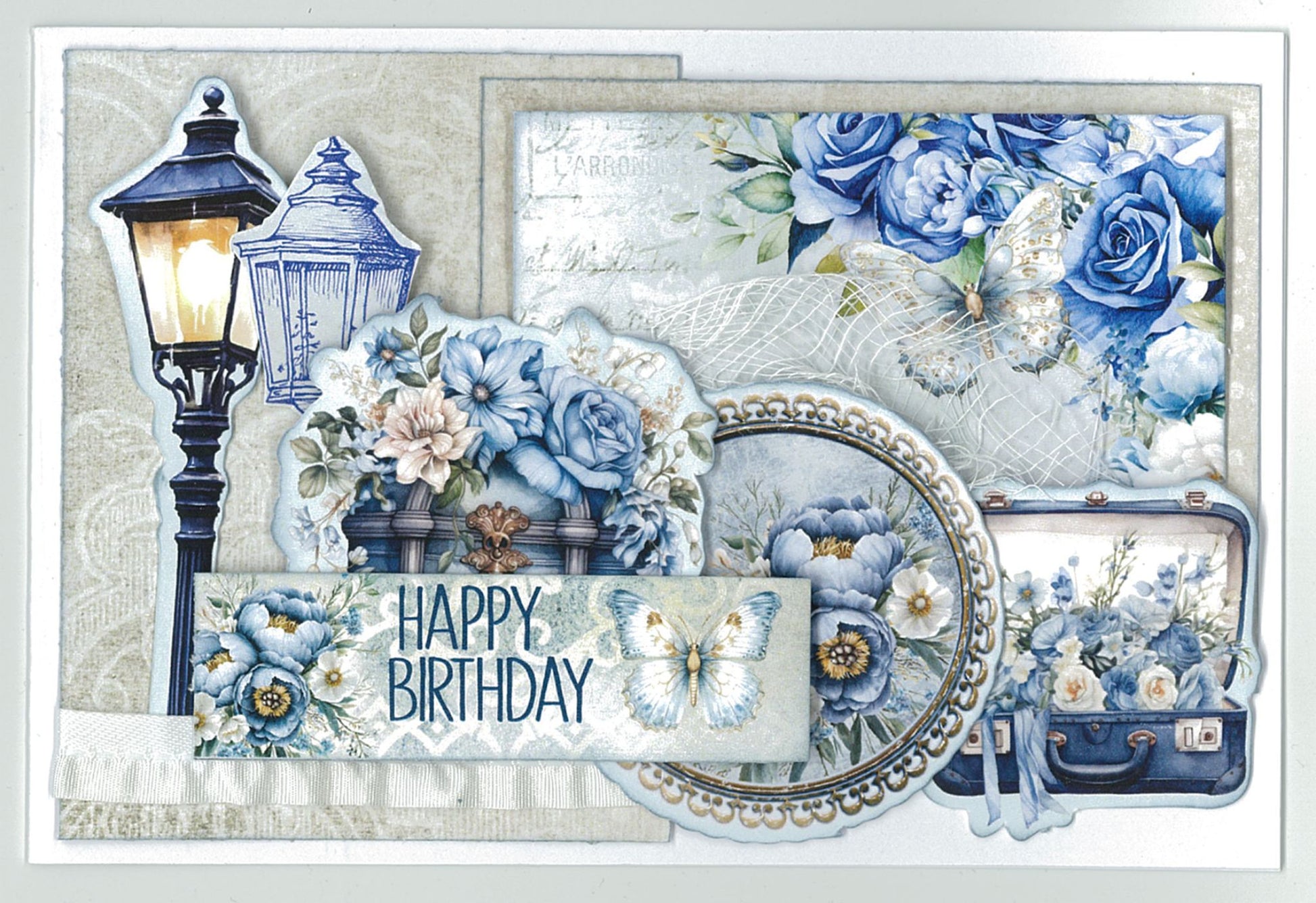 Twilight Ink 6x4 Card Making Kit by 3Quarter Designs — landscape Happy Birthday card with street lantern die-cut, vintage suitcase, pearl-framed cameo, butterfly, blue roses, peonies, and vintage postcard paper on cream background