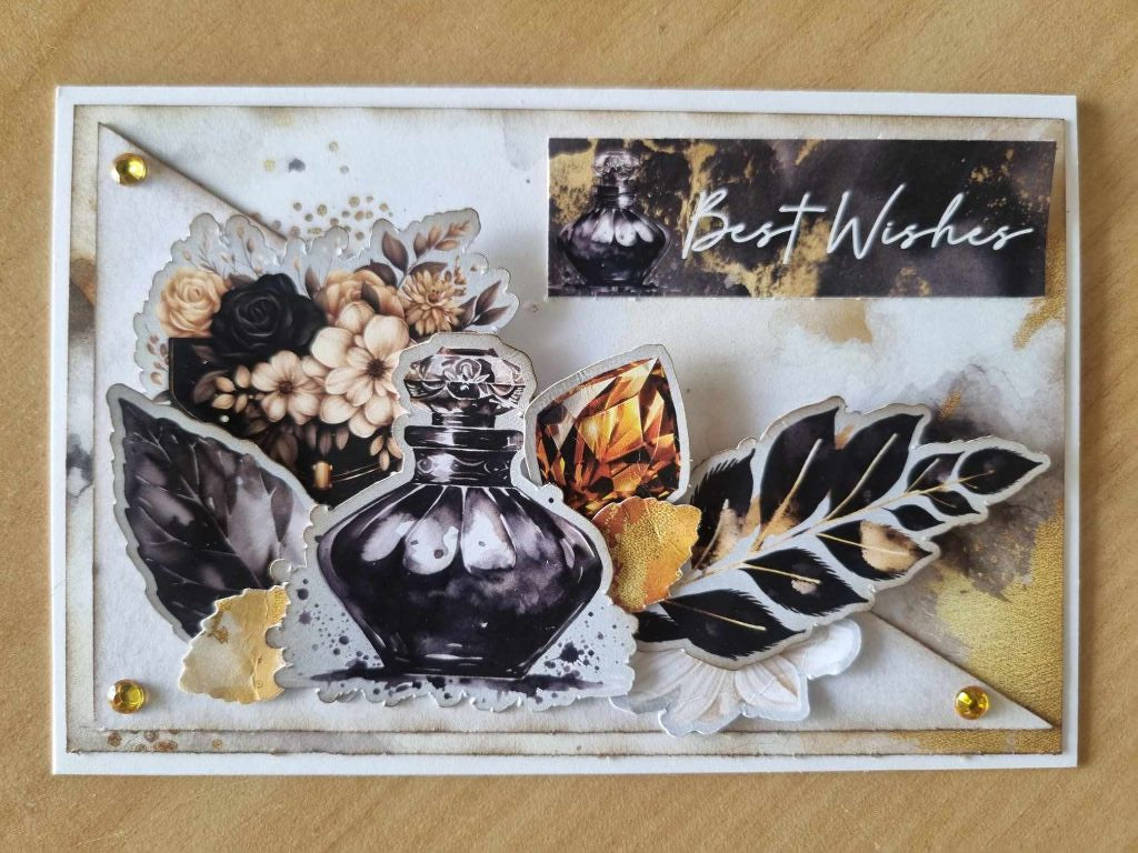 Golden Ebony Best Wishes sample card with black perfume bottle, amber gem, dark leaves and ivory flowers