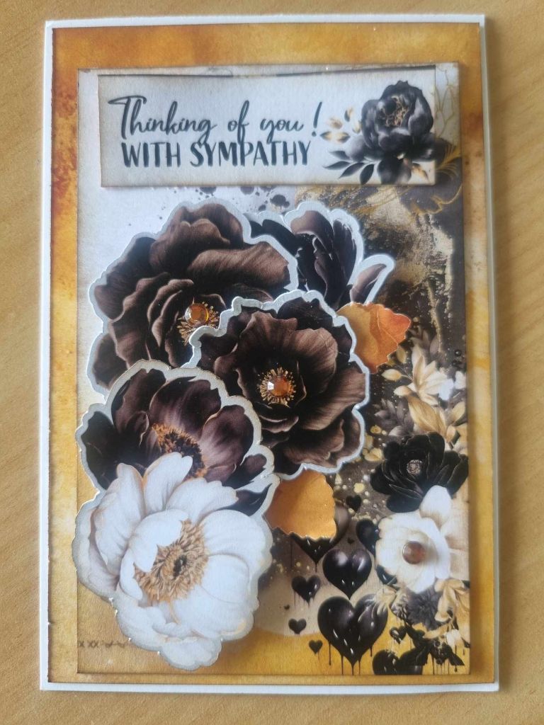 Golden Ebony Thinking of you with sympathy sample card with dark and white flowers on a gold background