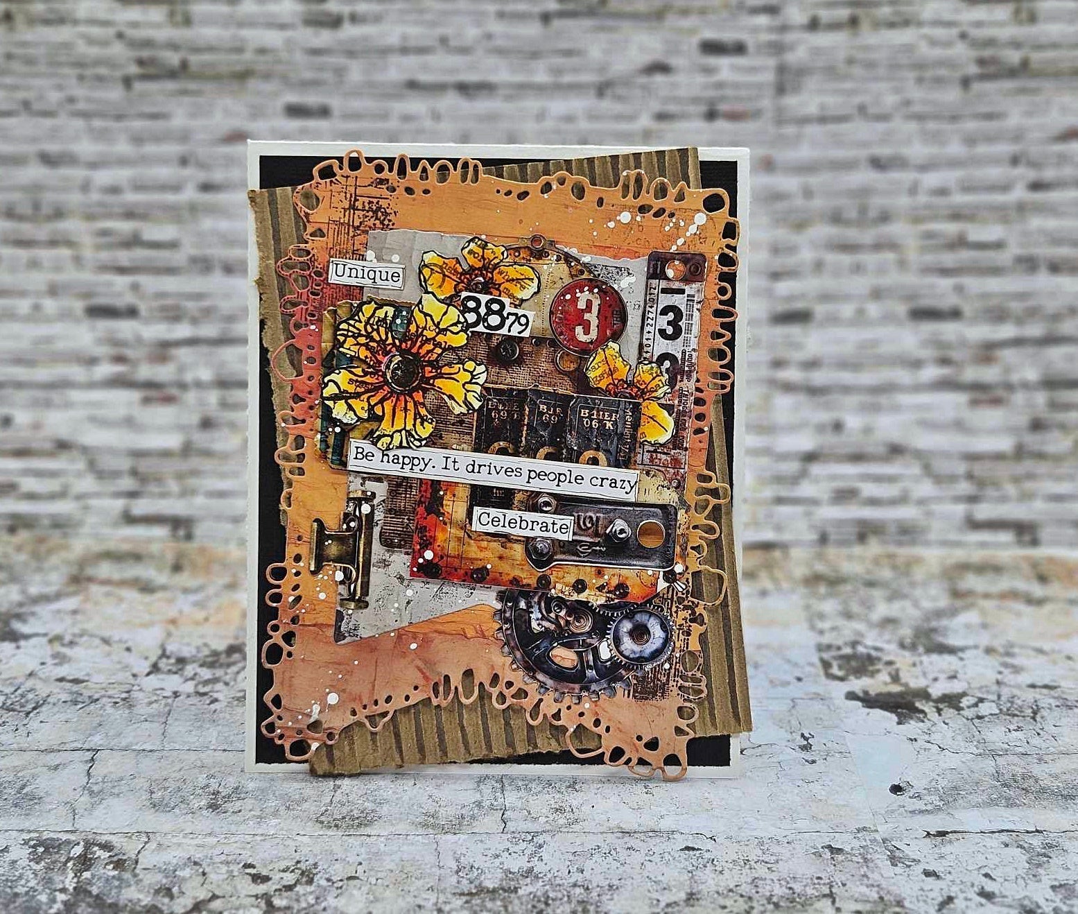 Steampunk card made with AALL & Create Bronze & Brassy Days papers featuring 'Be happy. It drives people crazy' and 'Celebrate' sentiments, yellow sunflowers, vintage numbers, gears, and distressed bronze and orange layered backgrounds