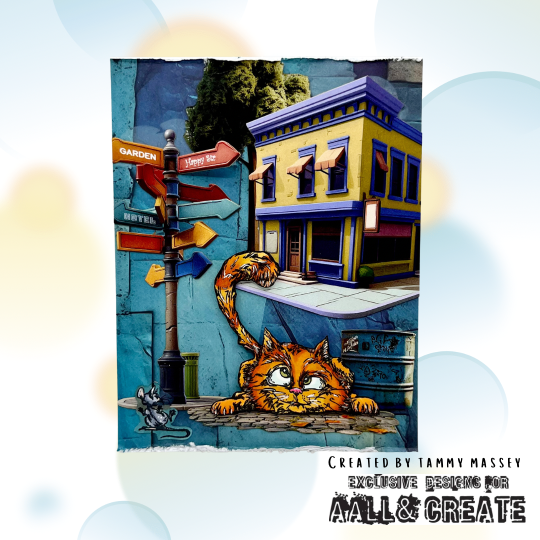 Whimsical art card made with AALL & Create Bronze & Brassy Days papers featuring orange cat character with mouse in colourful street scene with yellow and purple buildings, turquoise distressed background, and directional signpost