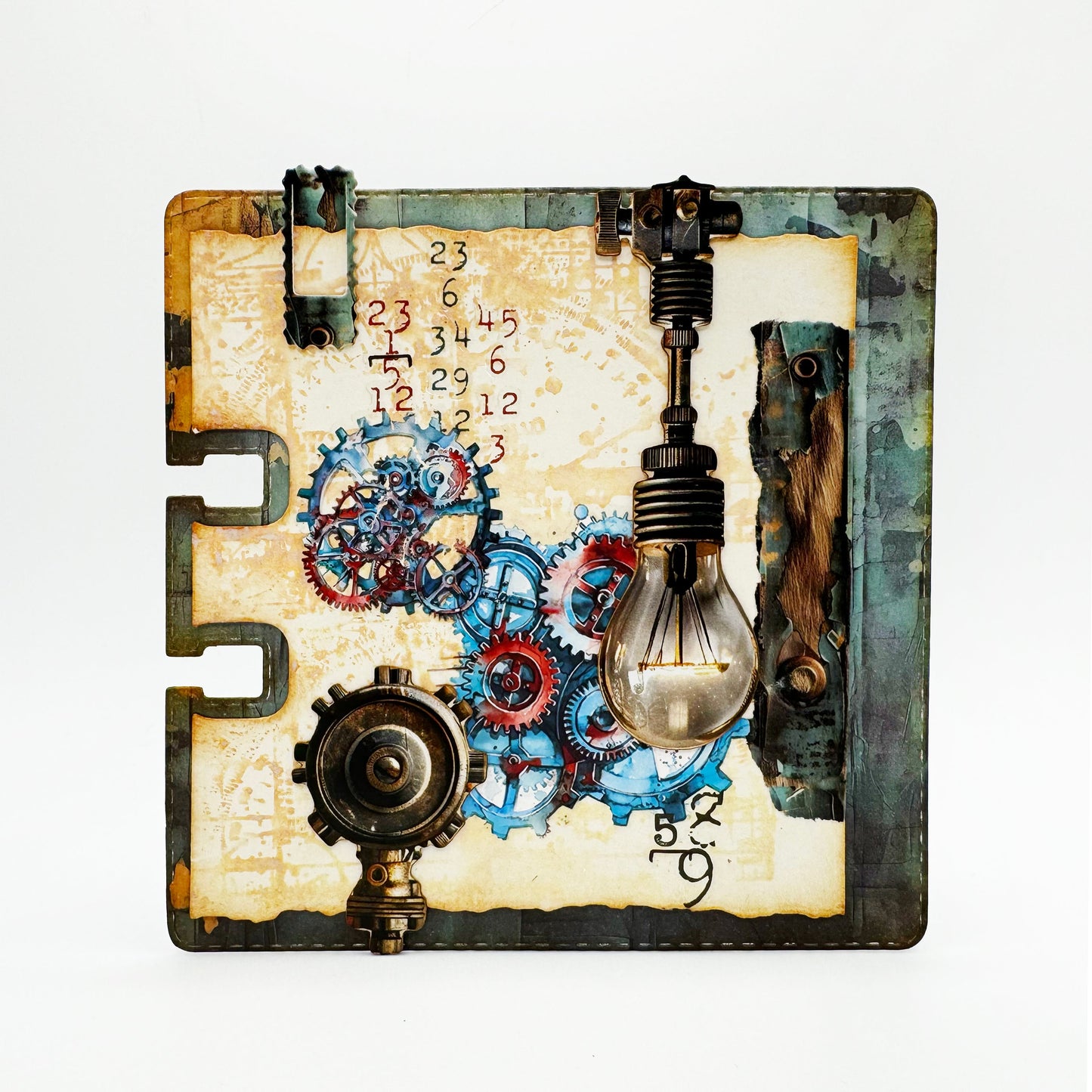 Mixed media index card made with AALL & Create Cogs & Curios rub-ons featuring turquoise and coral mechanical gears, vintage numbers, light bulb embellishment, and distressed cream background with industrial hardware accents